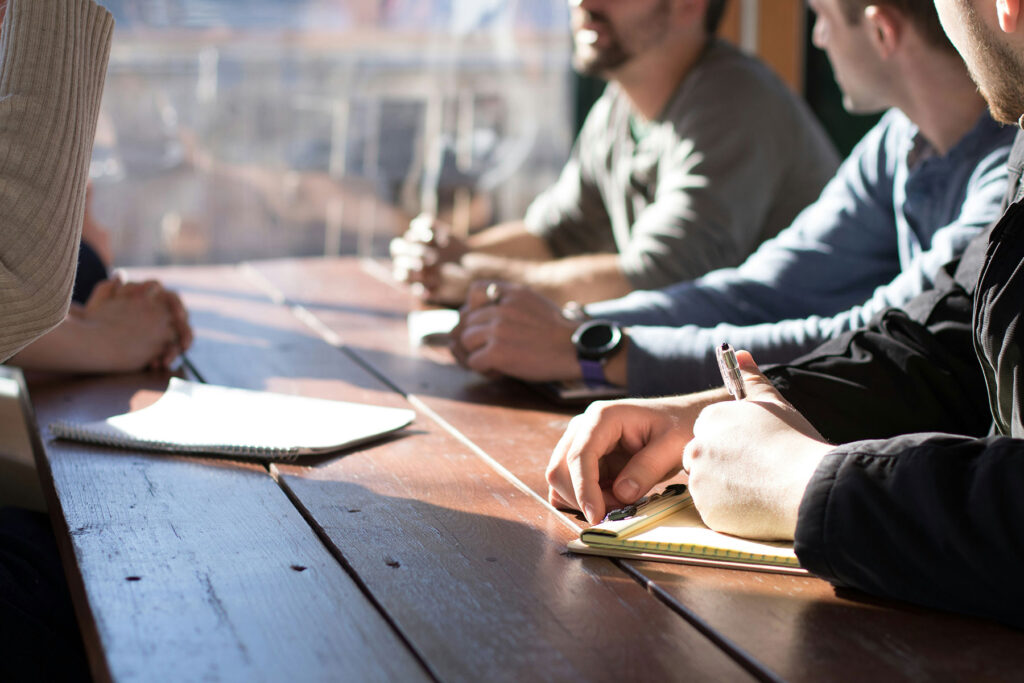 meeting at wooden table sunshine