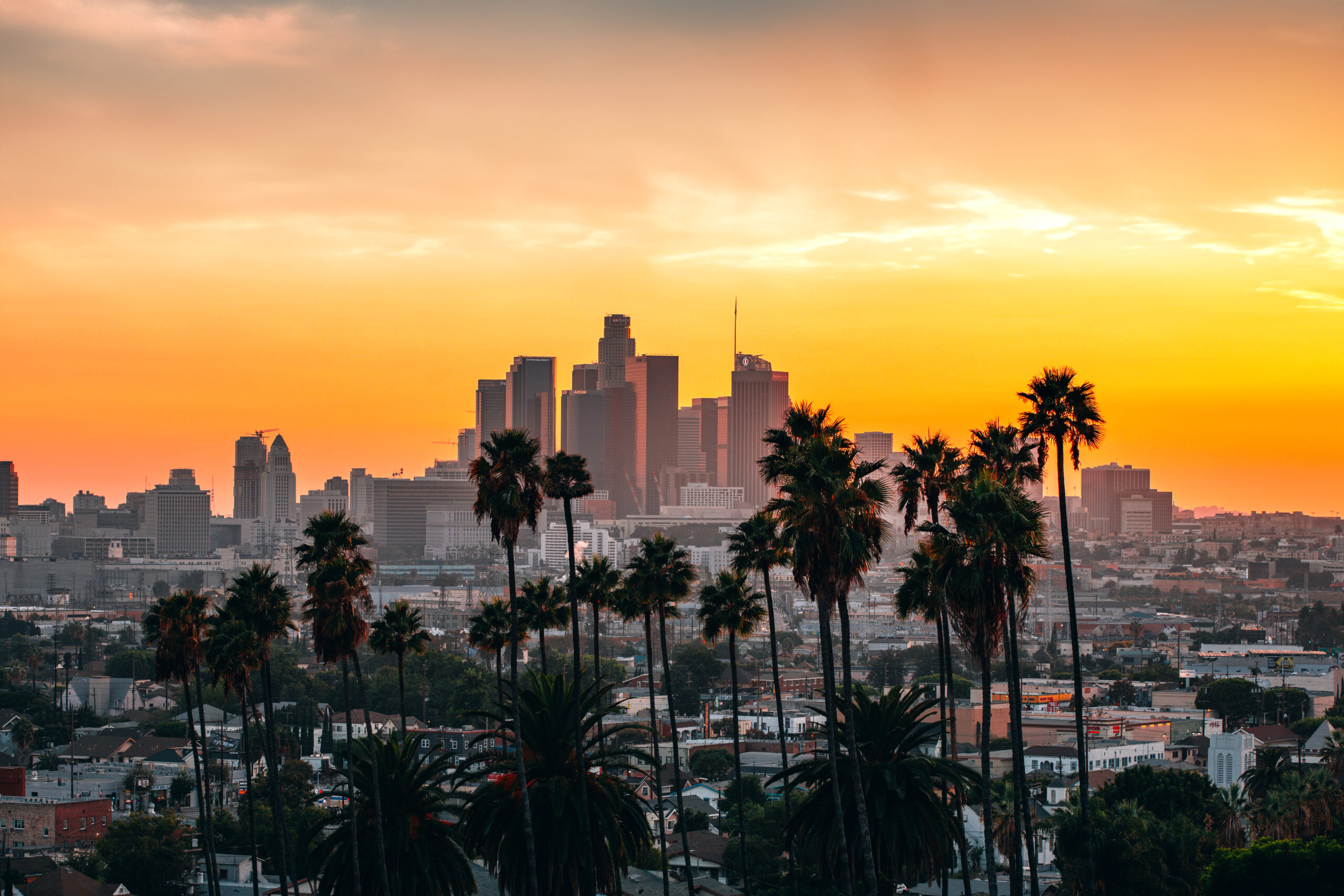 Beautiful orange sunset in SoCal over LA downtown skyscrapers.